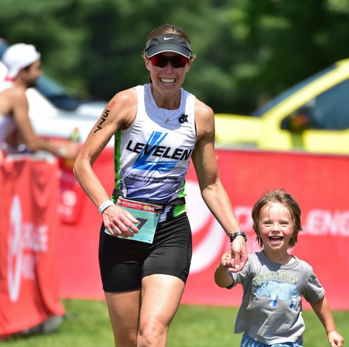 LEVELEN athlete finishing a race with her child